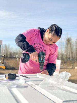 Volunteer working on hanging a door at Habitat for Humanity-Spokane’s Women Build in 2022