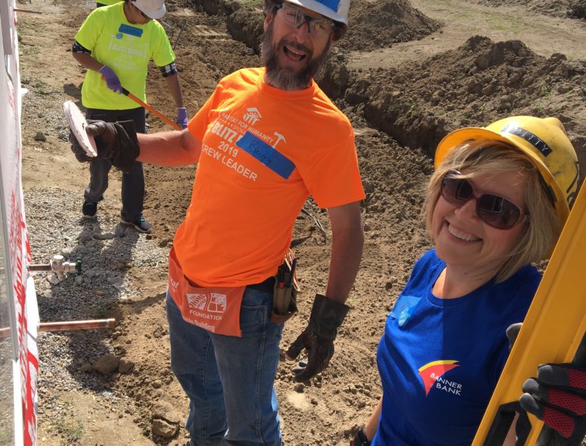 Two volunteers doing siding