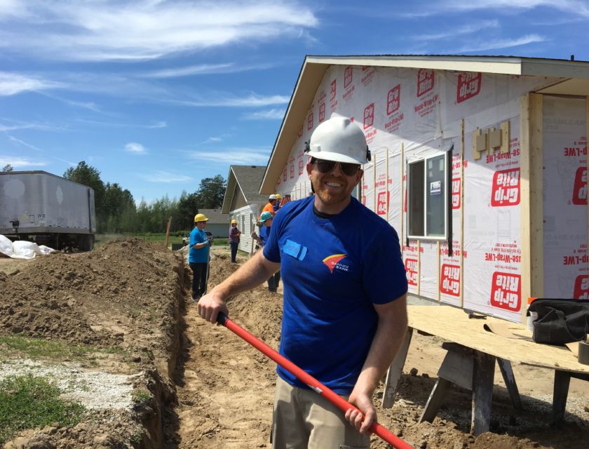 Male volunteer holding a shovel
